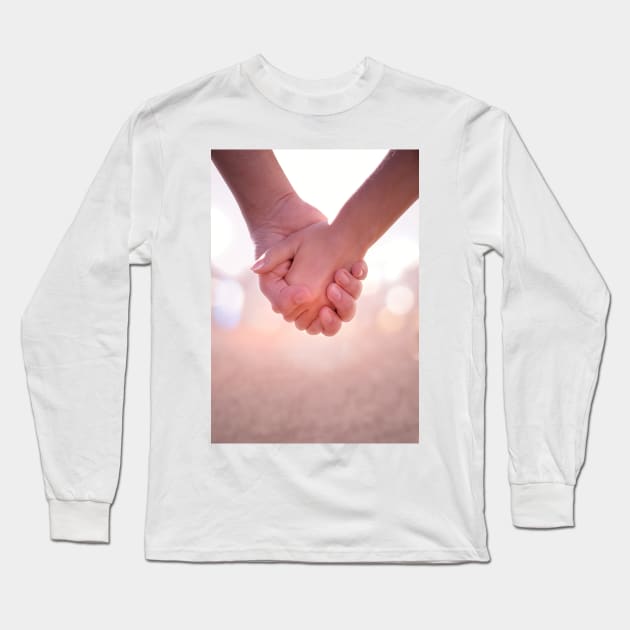 Close up of young female and male hands holding. Long Sleeve T-Shirt by victorhabbick